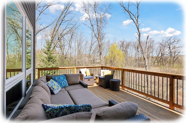 wooden terrace with an outdoor living space