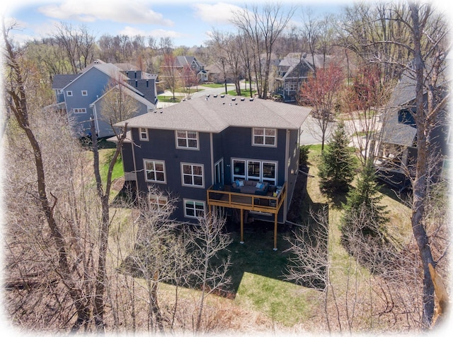 rear view of property with a residential view and a wooden deck