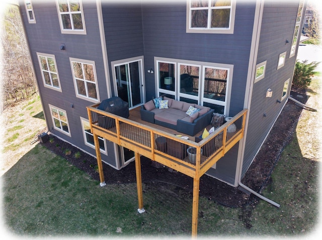 rear view of house featuring an outdoor living space and a deck