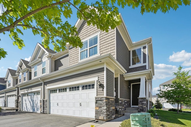 11462 81st Pl N, Maple Grove, MN 55369 - townhome / multi-family property featuring a garage, driveway, and stone siding