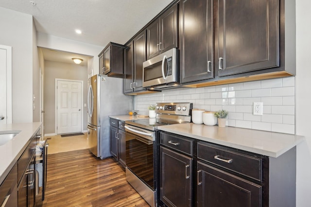 11462 81st Pl N, Maple Grove, MN 55369 - kitchen featuring appliances with stainless steel finishes, dark wood-style floors, tasteful backsplash, dark brown cabinets, and baseboards
