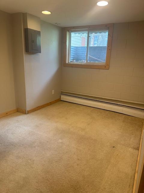 627 7th Ave S, Saint Cloud, MN 56301 - empty room featuring light carpet, a baseboard heating unit, recessed lighting, and electric panel