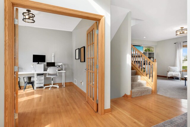office featuring baseboards, wood finished floors, and french doors