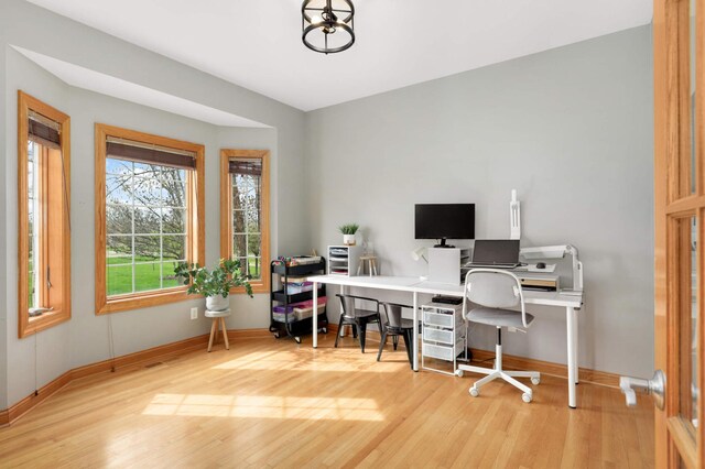 home office featuring baseboards and wood finished floors