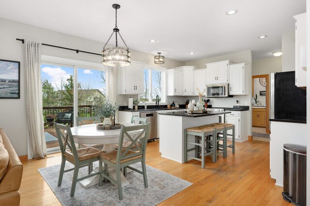 dining space with recessed lighting and light wood finished floors