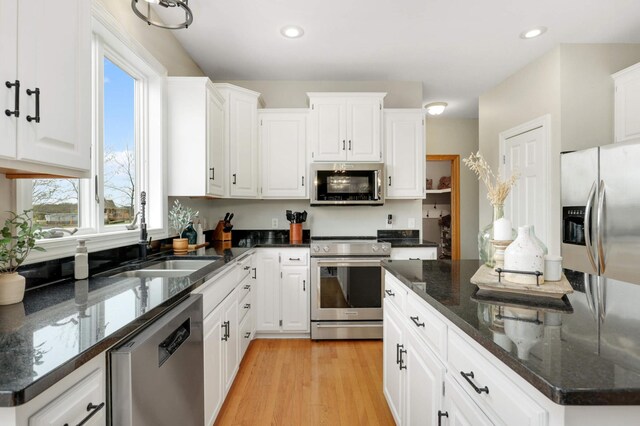 kitchen featuring white cabinetry, appliances with stainless steel finishes, and a sink