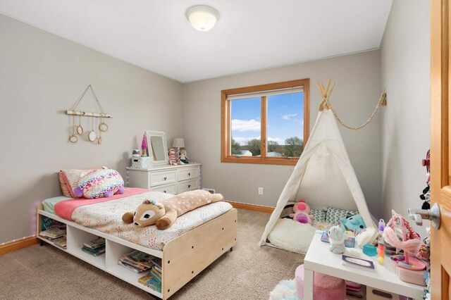 bedroom with baseboards and carpet