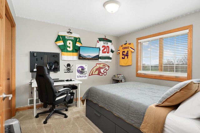 carpeted bedroom featuring baseboards and visible vents
