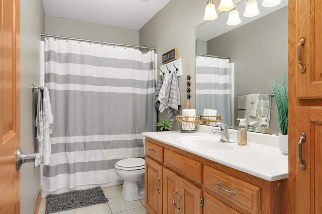 bathroom featuring tile patterned flooring, curtained shower, toilet, and vanity