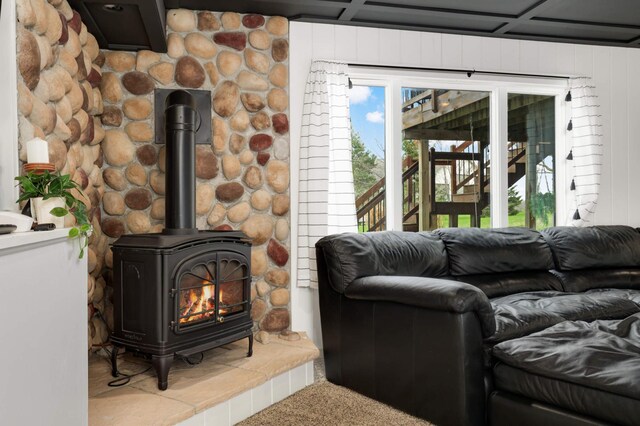 carpeted living room featuring a wood stove