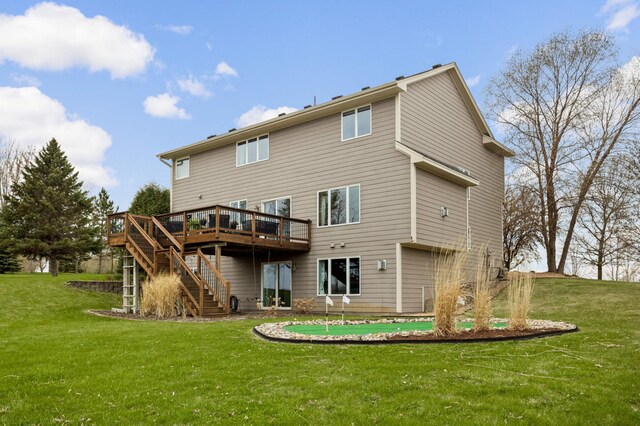back of house with a lawn, a wooden deck, and stairway
