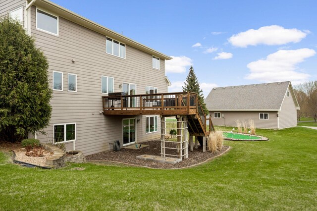 rear view of property featuring a yard, stairway, and a wooden deck