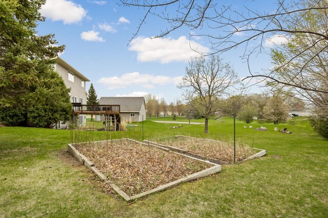view of yard featuring stairway, a deck, and a garden