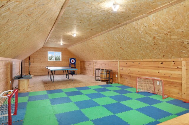 playroom with wooden walls, tile patterned floors, and lofted ceiling