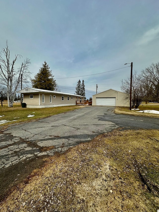 1404 Central Rd, Littlefork, MN 56653 - view of front facade with a detached garage, an outbuilding, and a front yard