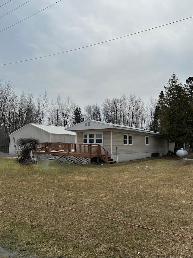 1404 Central Rd, Littlefork, MN 56653 - view of front of home with a deck and a front lawn