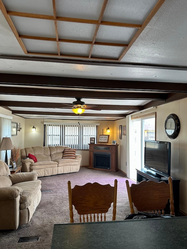 1404 Central Rd, Littlefork, MN 56653 - carpeted living room with a ceiling fan, beam ceiling, and a fireplace