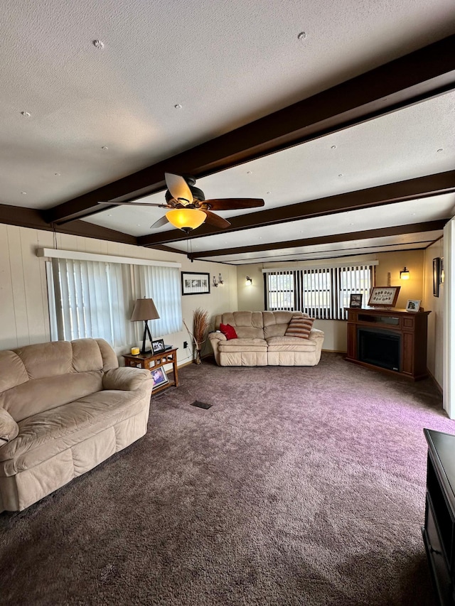 1404 Central Rd, Littlefork, MN 56653 - living area featuring carpet flooring, a fireplace, a textured ceiling, a ceiling fan, and beamed ceiling