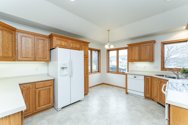 274 Dawn Ave, Saint Charles, MN 55972 - kitchen featuring white appliances, light countertops, brown cabinets, a sink, and hanging light fixtures