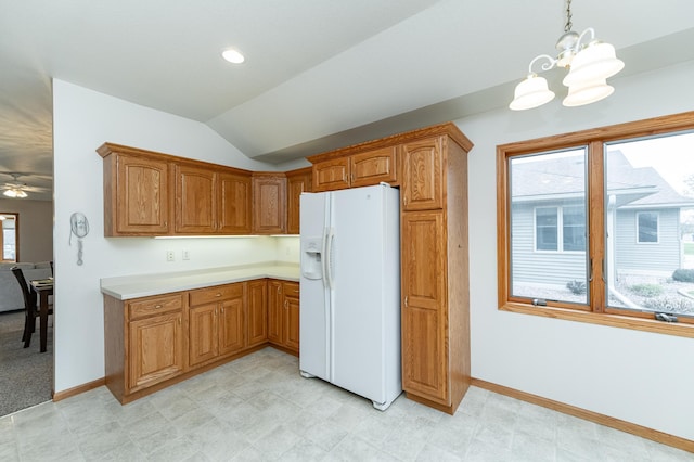 274 Dawn Ave, Saint Charles, MN 55972 - kitchen with baseboards, white refrigerator with ice dispenser, brown cabinets, and lofted ceiling