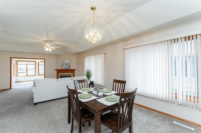 274 Dawn Ave, Saint Charles, MN 55972 - dining space with baseboards, carpet flooring, ceiling fan with notable chandelier, and a fireplace