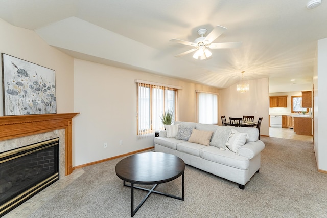 274 Dawn Ave, Saint Charles, MN 55972 - living area with light carpet, ceiling fan with notable chandelier, baseboards, lofted ceiling, and a high end fireplace