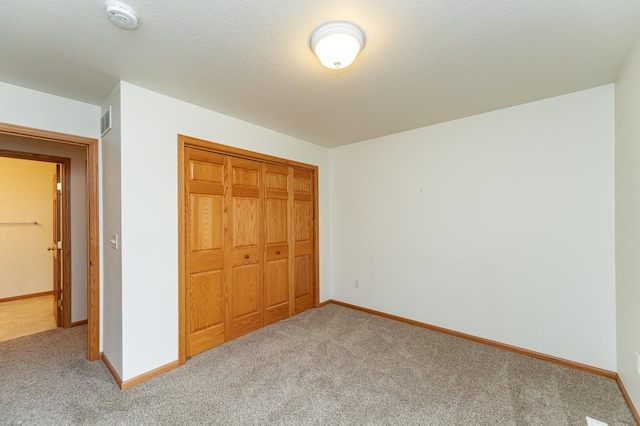 274 Dawn Ave, Saint Charles, MN 55972 - unfurnished bedroom with carpet floors, baseboards, a closet, and visible vents