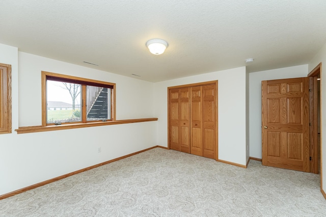 274 Dawn Ave, Saint Charles, MN 55972 - unfurnished bedroom featuring baseboards, a closet, and carpet flooring