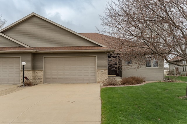 274 Dawn Ave, Saint Charles, MN 55972 - view of front of property with a garage, a front yard, roof with shingles, brick siding, and driveway