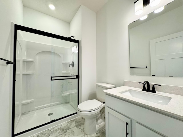 full bathroom with vanity, a shower stall, toilet, and marble finish floor