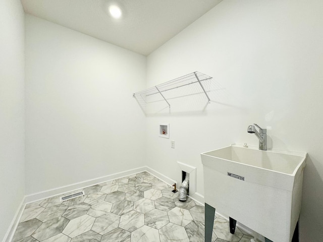 laundry area with laundry area, a sink, hookup for a washing machine, marble finish floor, and visible vents