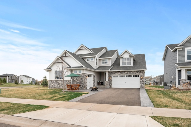 11270 Meadow View Ln, Maple Grove, MN 55311 - craftsman-style home featuring a garage, a front yard, aphalt driveway, and stone siding