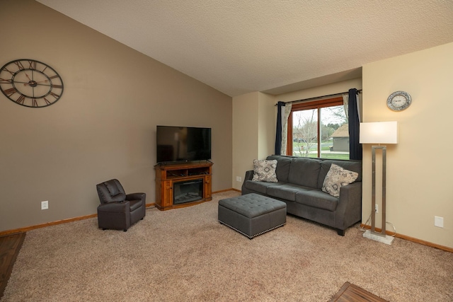 living room featuring carpet floors, baseboards, and vaulted ceiling