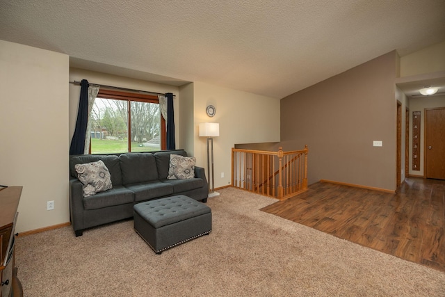 carpeted living area featuring baseboards and vaulted ceiling