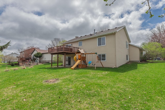 rear view of property with a playground, a wooden deck, and a lawn