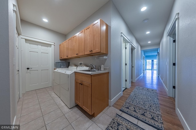 509 Superior Ave, Crosby, MN 56441 - laundry area featuring baseboards, light wood finished floors, independent washer and dryer, and cabinet space