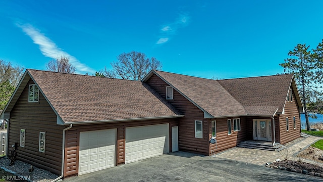 509 Superior Ave, Crosby, MN 56441 - chalet / cabin featuring a garage, a shingled roof, log veneer siding, and french doors