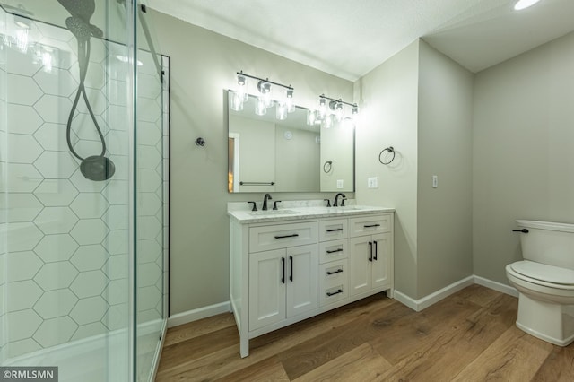 509 Superior Ave, Crosby, MN 56441 - bathroom featuring a sink, toilet, baseboards, a shower stall, and wood finished floors