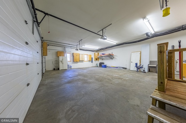 509 Superior Ave, Crosby, MN 56441 - garage featuring white fridge with ice dispenser and a garage door opener