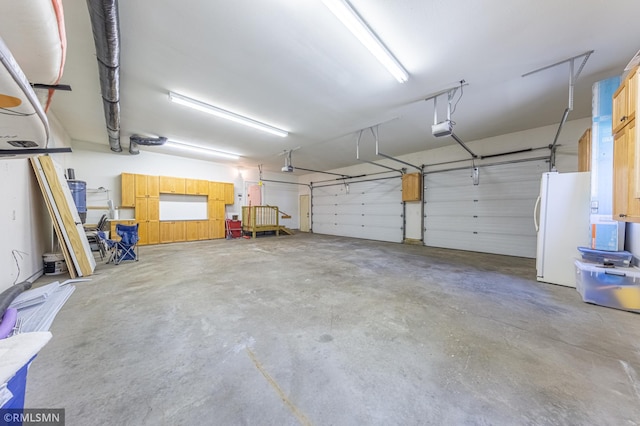 509 Superior Ave, Crosby, MN 56441 - garage with a garage door opener and freestanding refrigerator