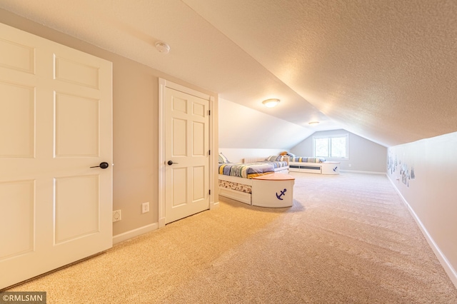 509 Superior Ave, Crosby, MN 56441 - bedroom featuring carpet floors, baseboards, vaulted ceiling, and a textured ceiling