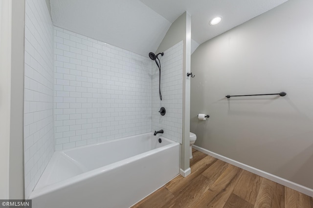 509 Superior Ave, Crosby, MN 56441 - bathroom featuring vaulted ceiling, wood finished floors, baseboards, toilet, and bathing tub / shower combination