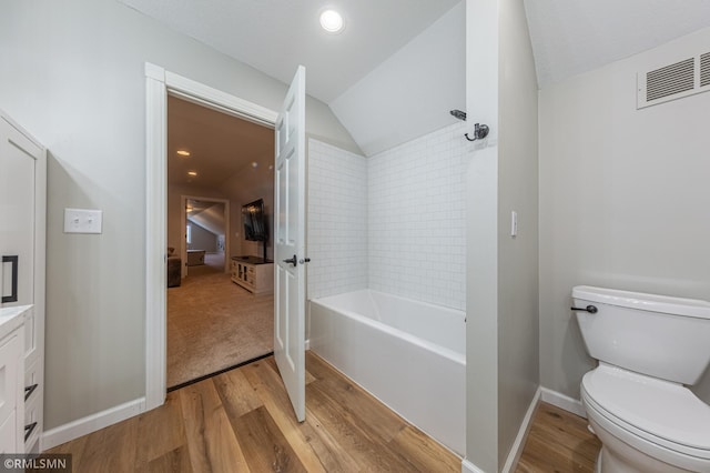 509 Superior Ave, Crosby, MN 56441 - full bath with wood finished floors, lofted ceiling, toilet, baseboards, and bathtub / shower combination