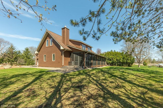 509 Superior Ave, Crosby, MN 56441 - back of house with a yard, a chimney, a sunroom, and log veneer siding