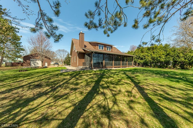 509 Superior Ave, Crosby, MN 56441 - back of house with a lawn, an outdoor structure, a chimney, and a sunroom