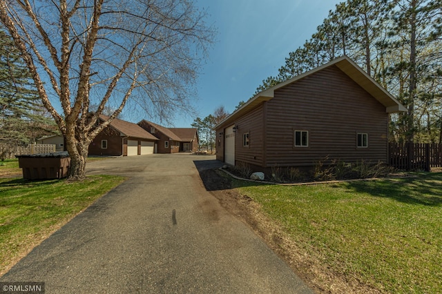 509 Superior Ave, Crosby, MN 56441 - view of property exterior featuring a yard, log veneer siding, and fence