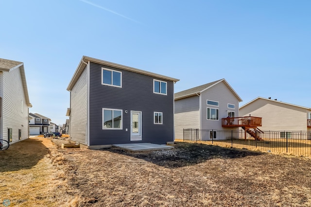 back of property featuring fence and a patio area