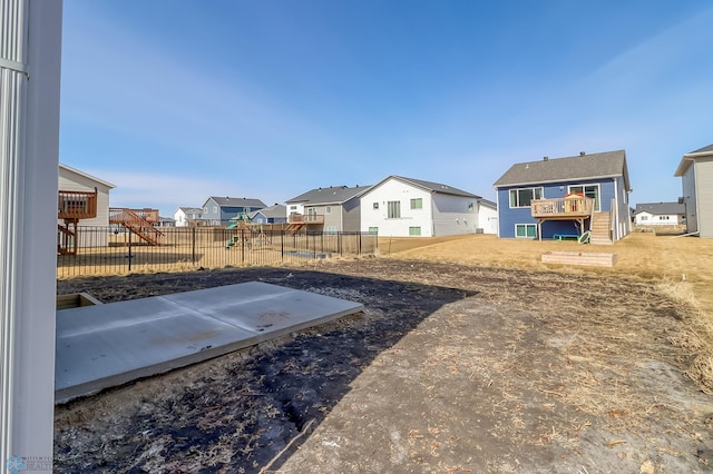 view of yard featuring a residential view, fence, and a deck