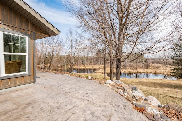 view of patio with a water view