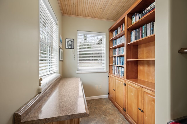 doorway featuring crown molding, wooden ceiling, and baseboards